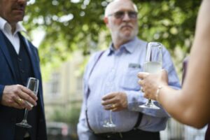 Old men having a discussion at a party